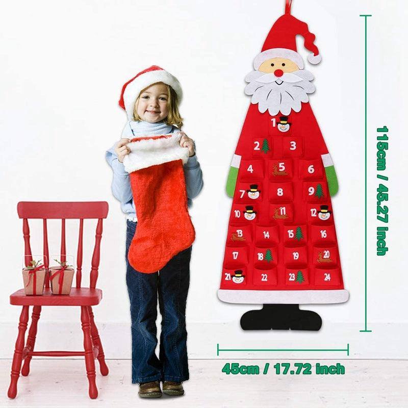 a little girl holding a christmas stocking next to a calendar