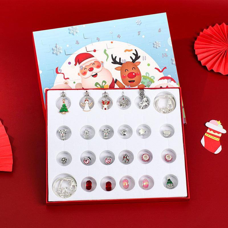 a box of christmas themed earrings on a red background