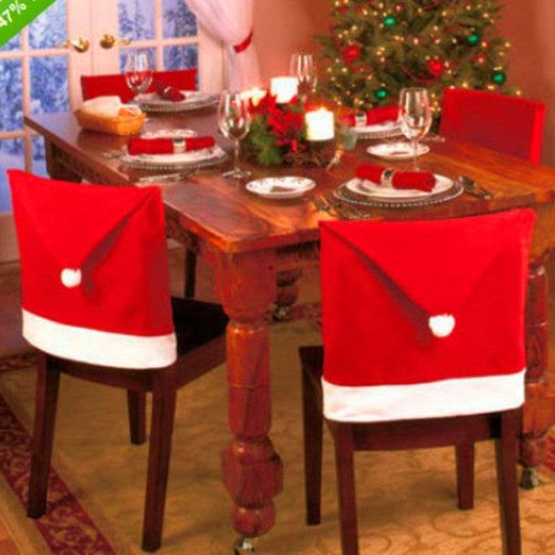 a dining room table decorated for christmas with a christmas tree in the background