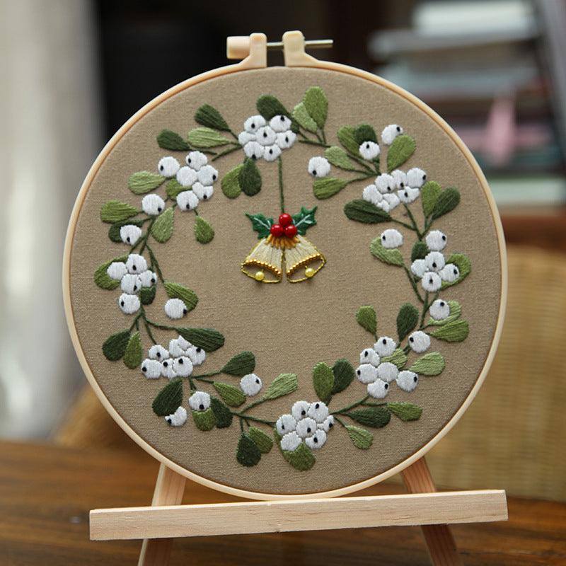 a picture of a embroidery project with a bell and flowers
