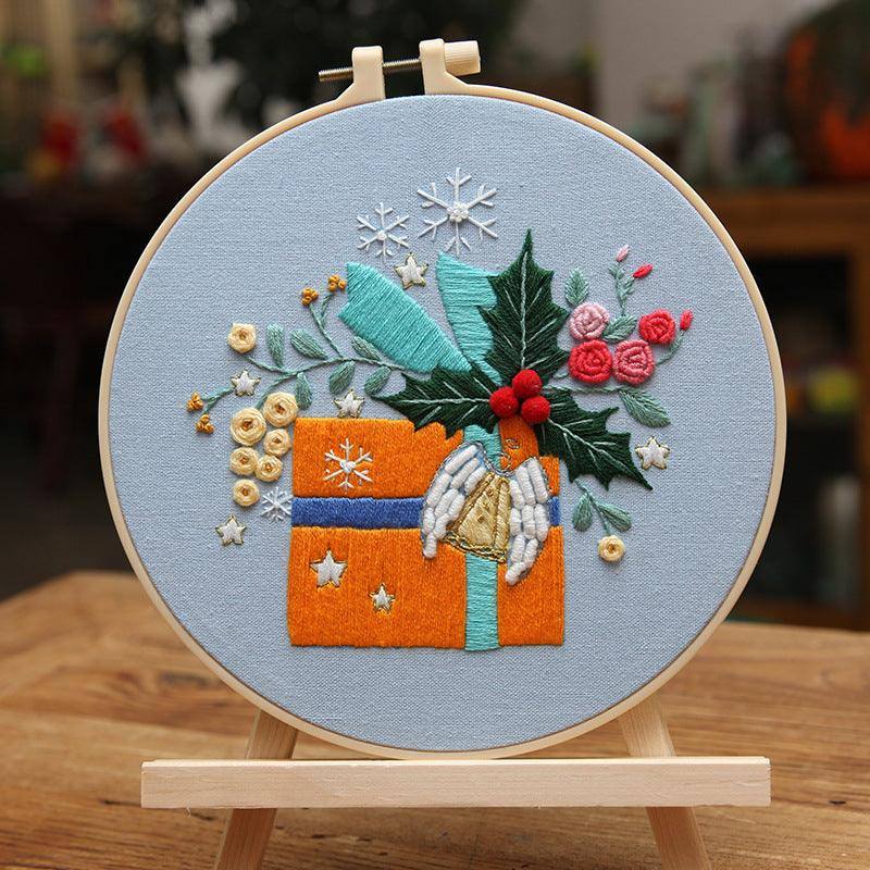 a hand embroidered picture of a christmas present