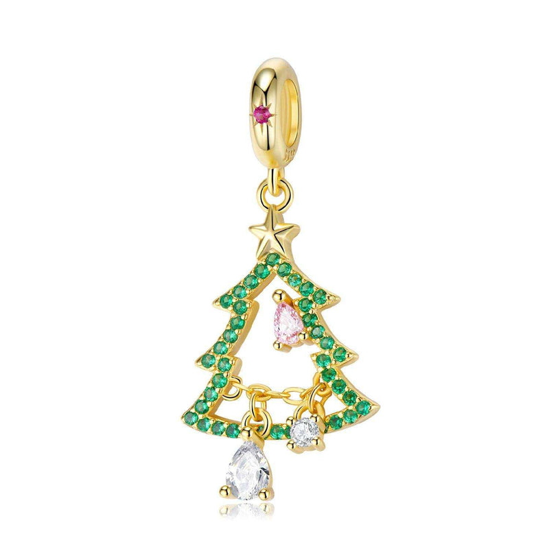 a gold charm with a christmas tree on it